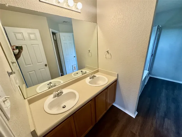 a bathroom with a sink a mirror and a sink