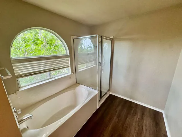 a view of an empty room and wooden floor
