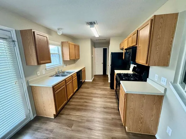 a kitchen with stainless steel appliances a microwave a sink and a refrigerator