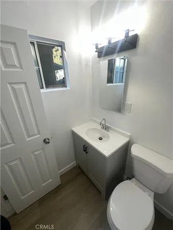 a white toilet sitting next to a white sink