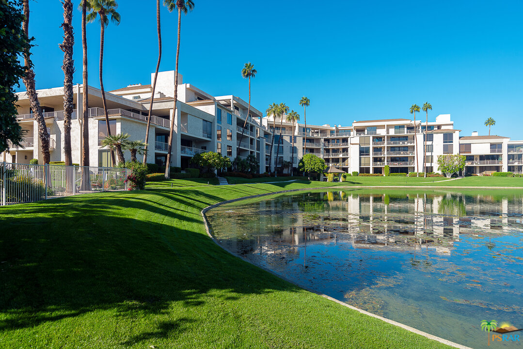 910 Island Drive, Unit 107 Rancho Mirage, CA 92270 - Photo 1 of 23 a view of a large building with a yard