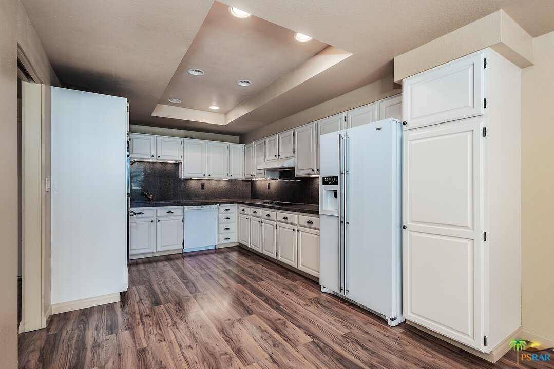 910 Island Drive, Unit 107 Rancho Mirage, CA 92270 - Photo 12 of 23 a kitchen with stainless steel appliances a refrigerator sink and cabinets