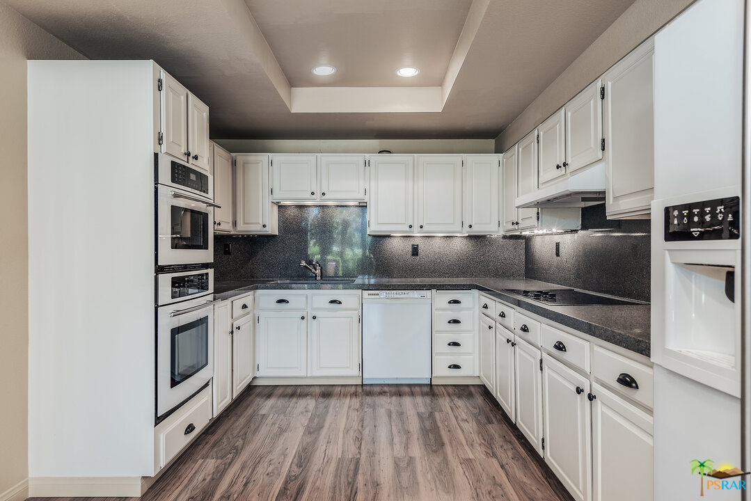 910 Island Drive, Unit 107 Rancho Mirage, CA 92270 - Photo 13 of 23 a kitchen with cabinets stainless steel appliances and a counter space