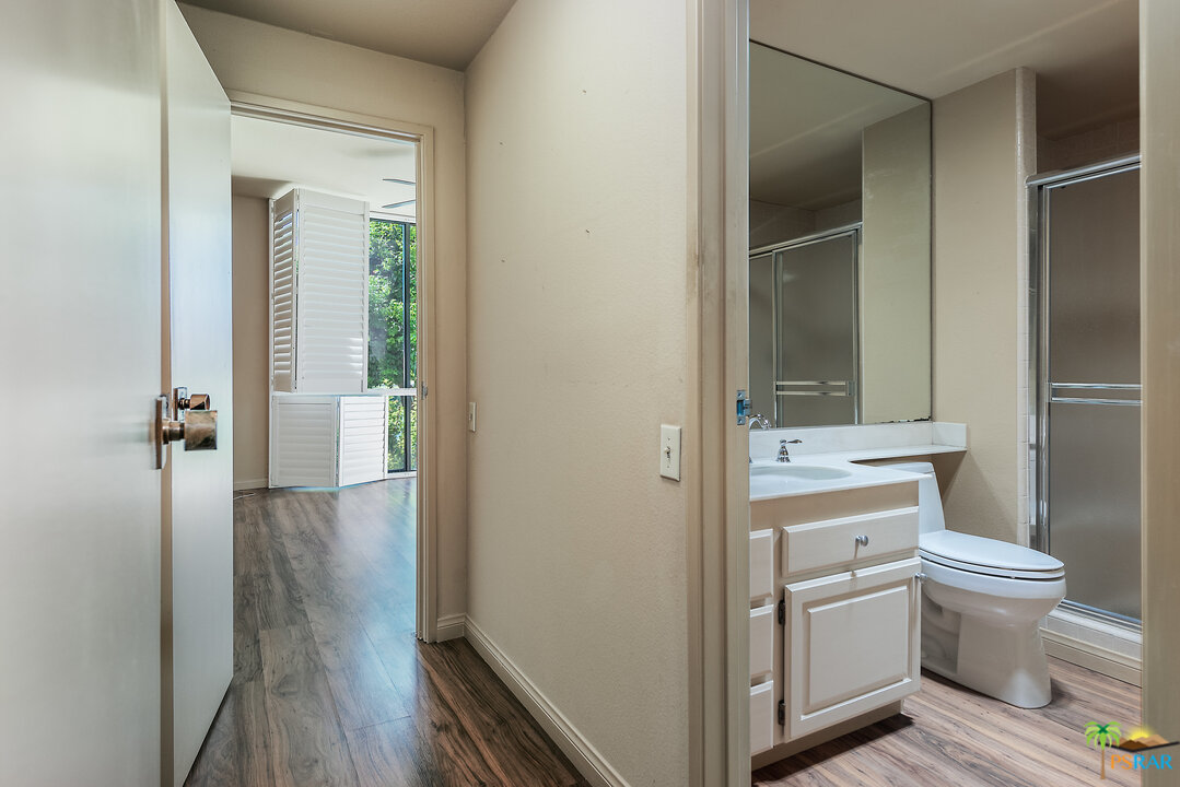 910 Island Drive, Unit 107 Rancho Mirage, CA 92270 - Photo 14 of 23 a bathroom with a toilet sink and a mirror