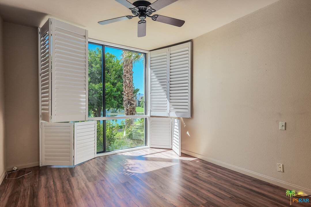 910 Island Drive, Unit 107 Rancho Mirage, CA 92270 - Photo 16 of 23 a view of a livingroom with wooden floor and a window