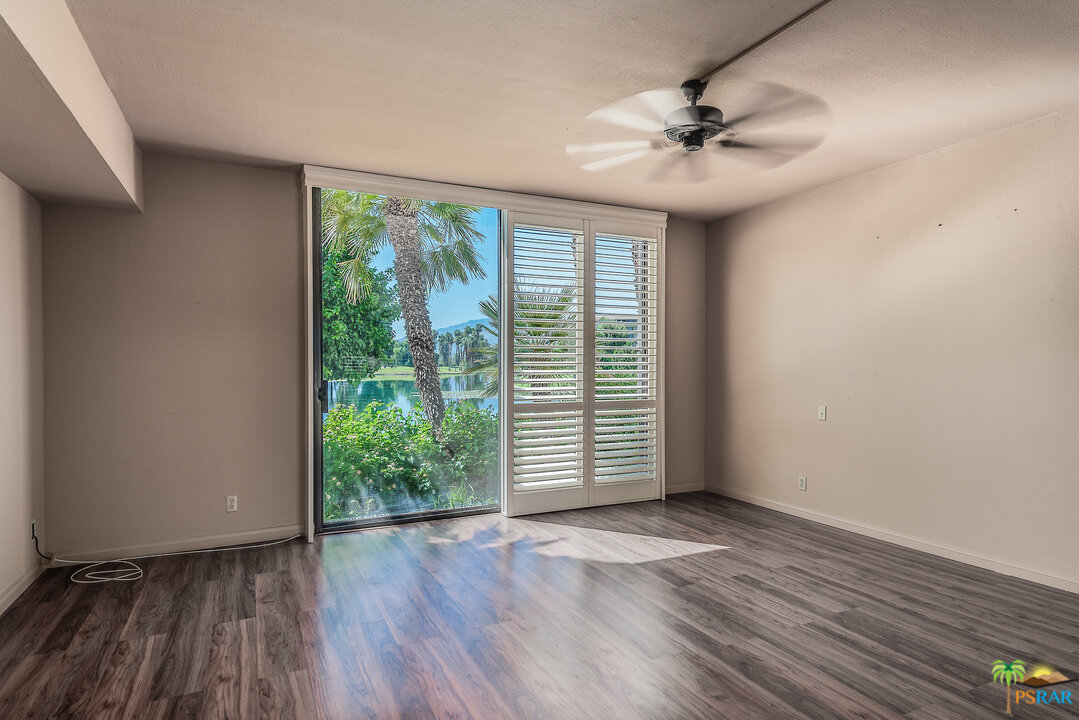 910 Island Drive, Unit 107 Rancho Mirage, CA 92270 - Photo 17 of 23 wooden floor in an empty room with a window