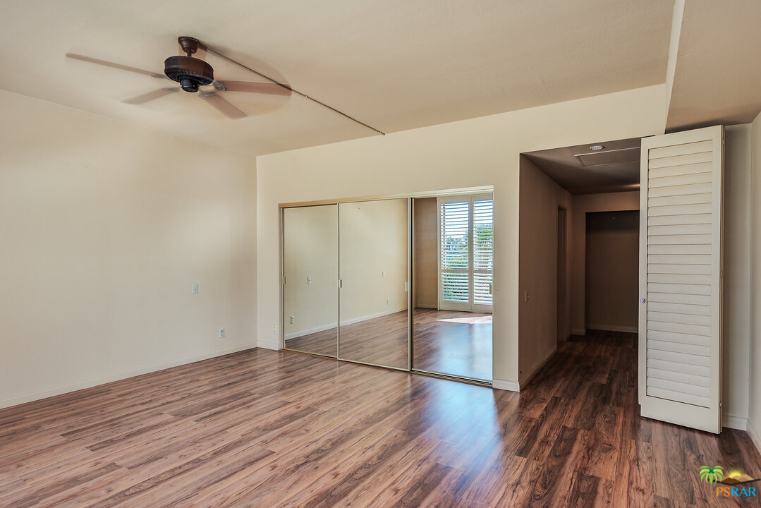 910 Island Drive, Unit 107 Rancho Mirage, CA 92270 - Photo 18 of 23 a view of empty room with wooden floor