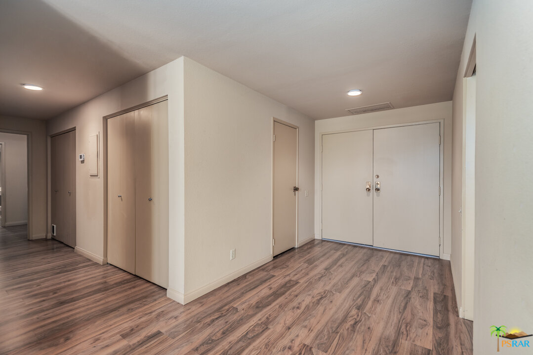 910 Island Drive, Unit 107 Rancho Mirage, CA 92270 - Photo 2 of 23 a view of hallway with wooden floor