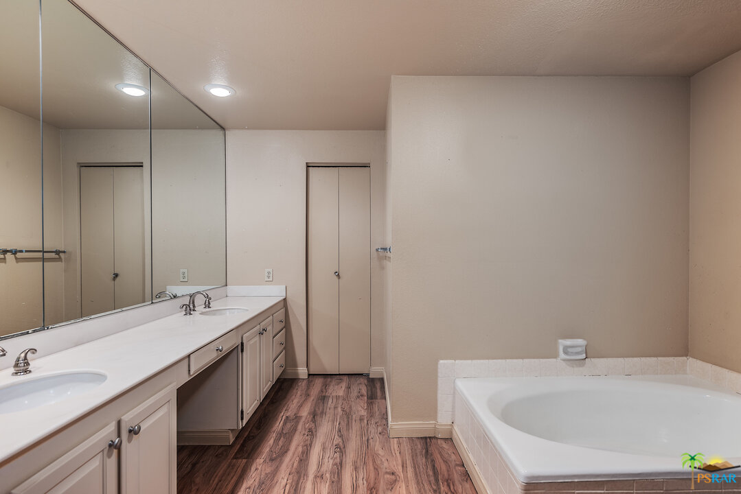 910 Island Drive, Unit 107 Rancho Mirage, CA 92270 - Photo 22 of 23 a bathroom with a tub sink and mirror