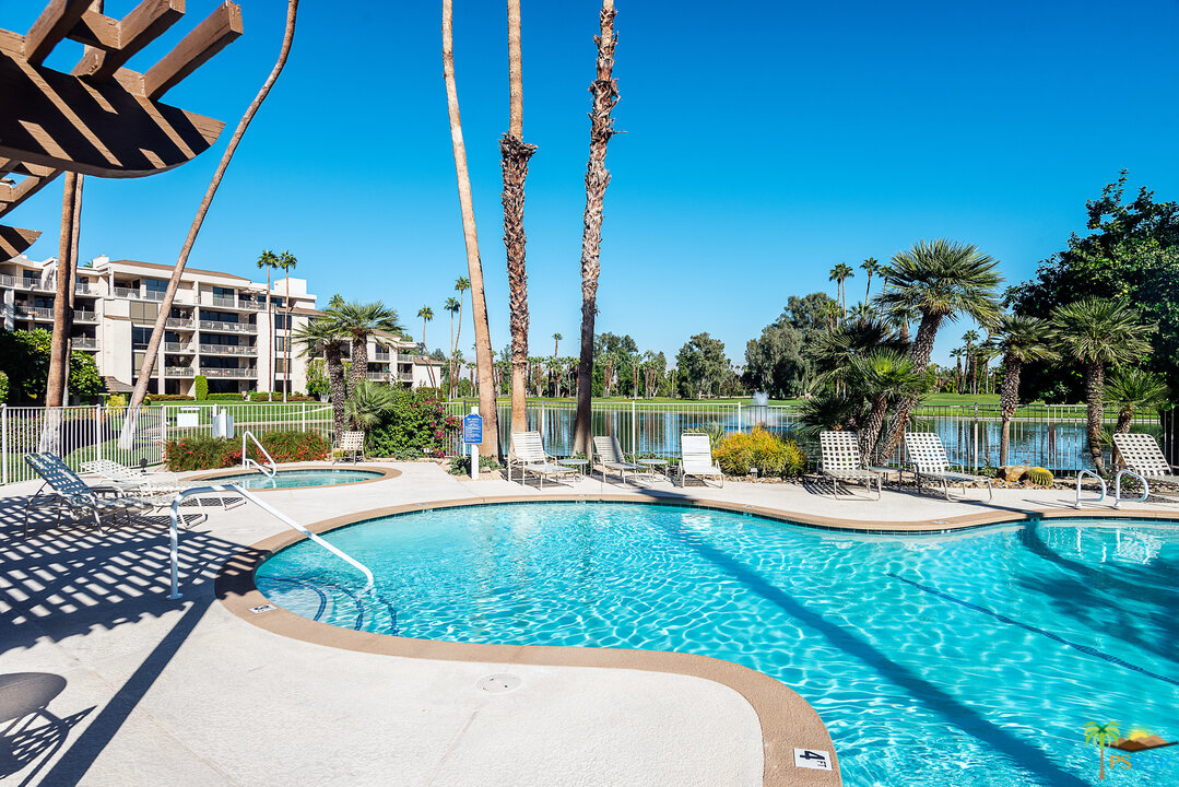 910 Island Drive, Unit 107 Rancho Mirage, CA 92270 - Photo 23 of 23 a view of a swimming pool with a lounge chairs
