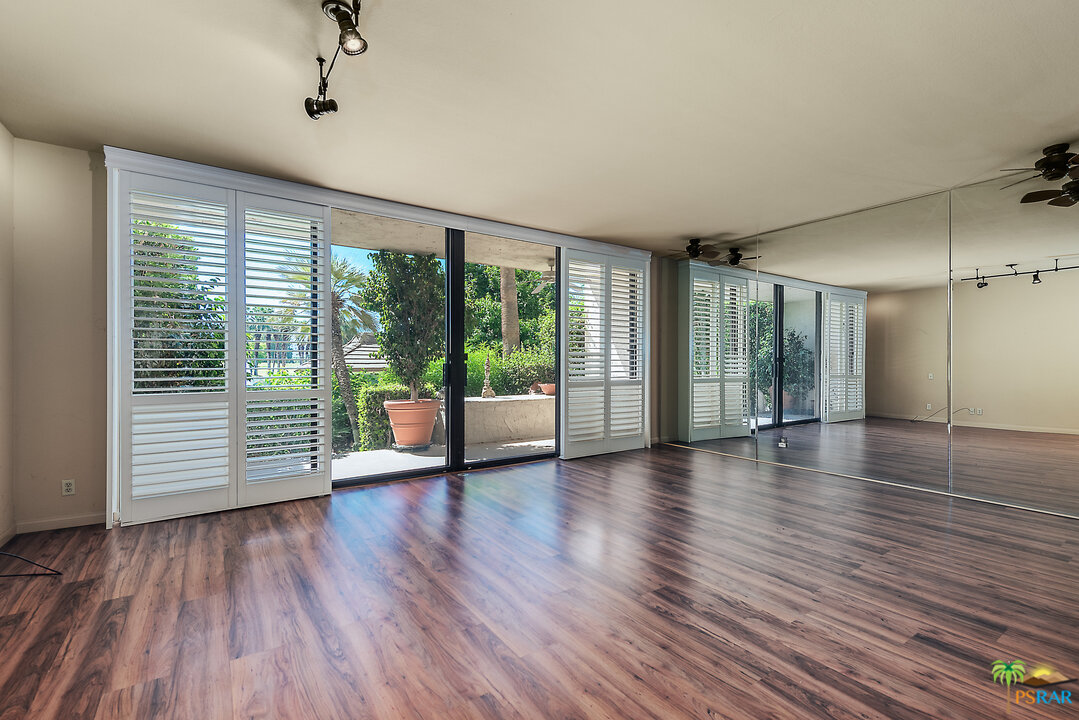 910 Island Drive, Unit 107 Rancho Mirage, CA 92270 - Photo 3 of 23 a view of room with furniture and wooden floor