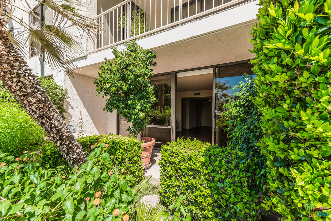 910 Island Drive, Unit 107 Rancho Mirage, CA 92270 - Photo 9 of 23 front view of a house with a tree