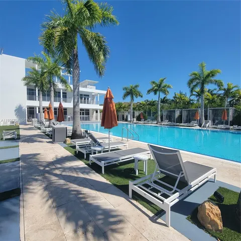 a roof deck with table and chairs potted plants and palm tree