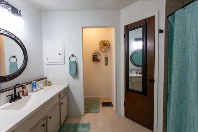 a bathroom with a sink mirror and vanity