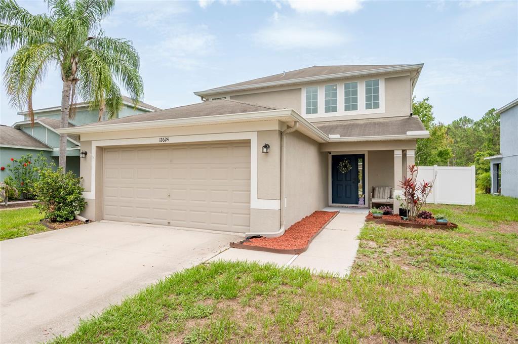 12624 White Bluff Road Hudson, FL 34669 - Photo 1 of 1 a front view of a house with a yard and garage