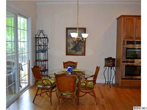 580 Quicksilver Trail Fort Mill, SC 29708 - Photo 7 of 16 a dining room with furniture a chandelier and wooden floor
