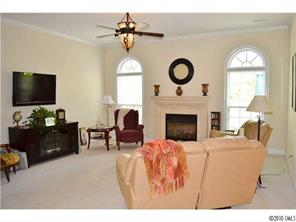 580 Quicksilver Trail Fort Mill, SC 29708 - Photo 8 of 16 a living room with furniture a fireplace and a flat screen tv
