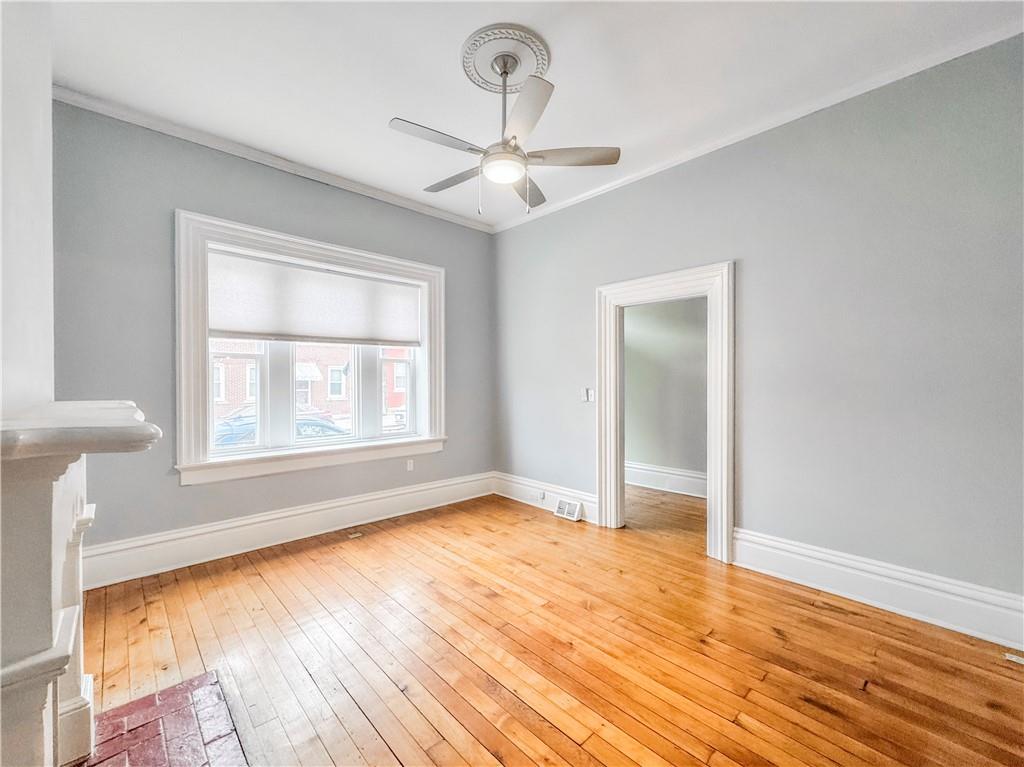 52 South 18th Street Pittsburgh, PA 15203 - Photo 11 of 26 a view of an empty room with wooden floor and a window