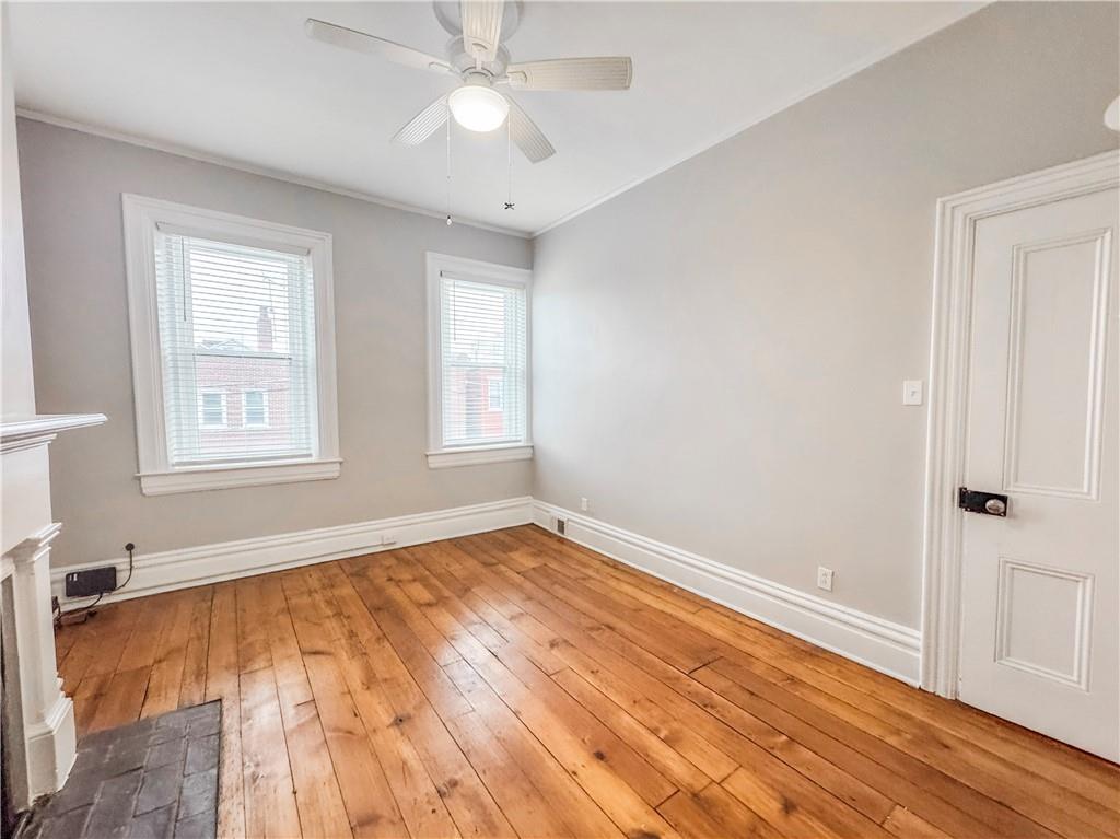 52 South 18th Street Pittsburgh, PA 15203 - Photo 22 of 26 a view of empty room with wooden floor and fan