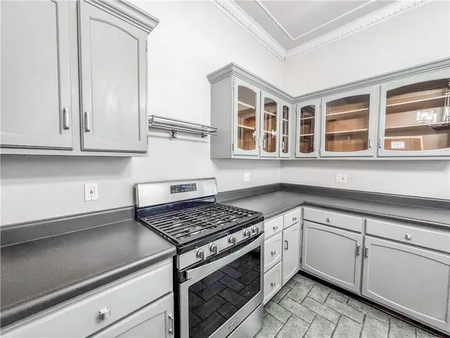 a kitchen with granite countertop white cabinets and white appliances