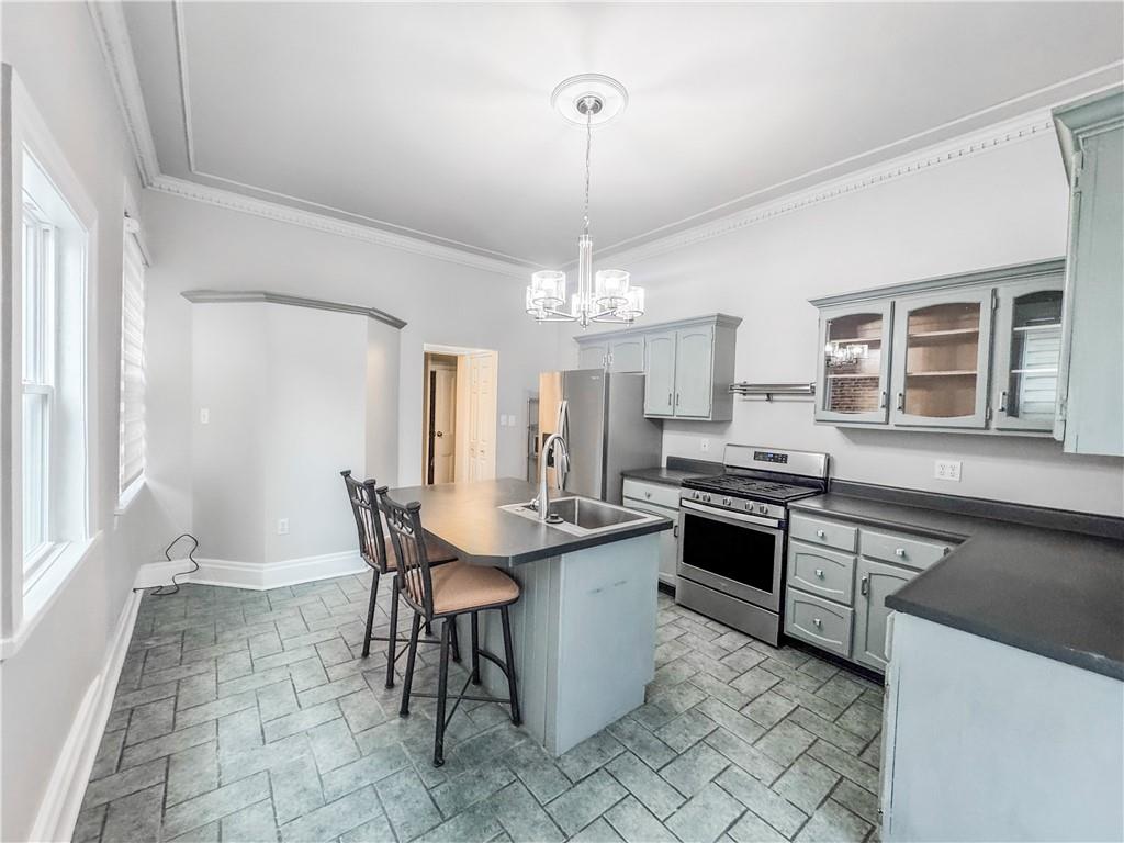 52 South 18th Street Pittsburgh, PA 15203 - Photo 4 of 26 a kitchen with stainless steel appliances a dining table chairs and granite counter tops