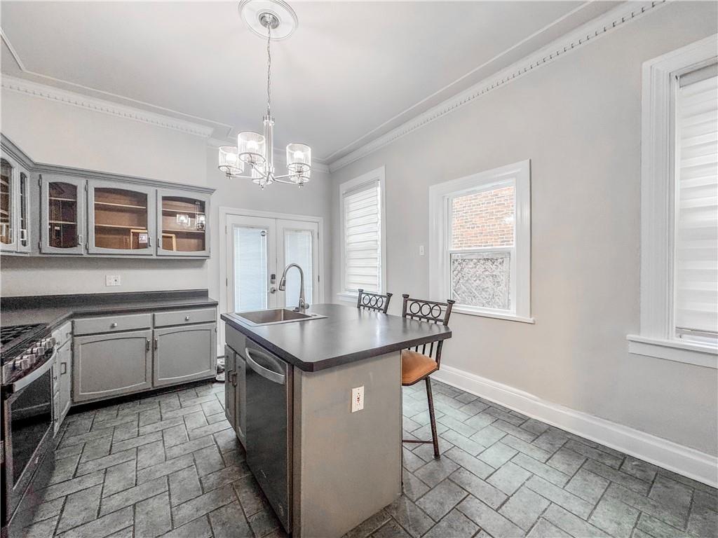 52 South 18th Street Pittsburgh, PA 15203 - Photo 5 of 26 a kitchen with sink cabinets and window
