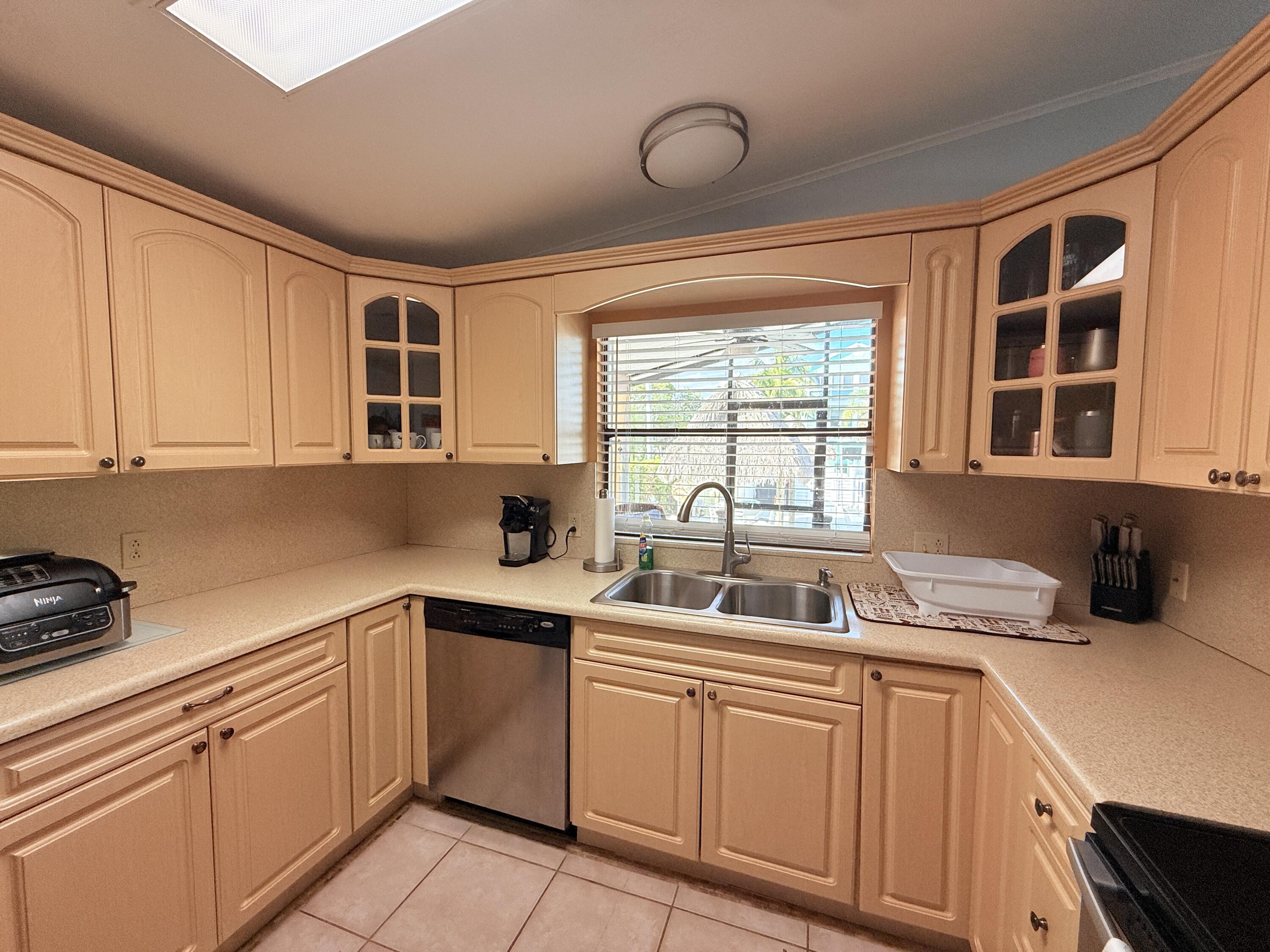 723 Boyd Drive Key Largo, FL 33037 - Photo 11 of 56 a kitchen with cabinets appliances a sink and a window