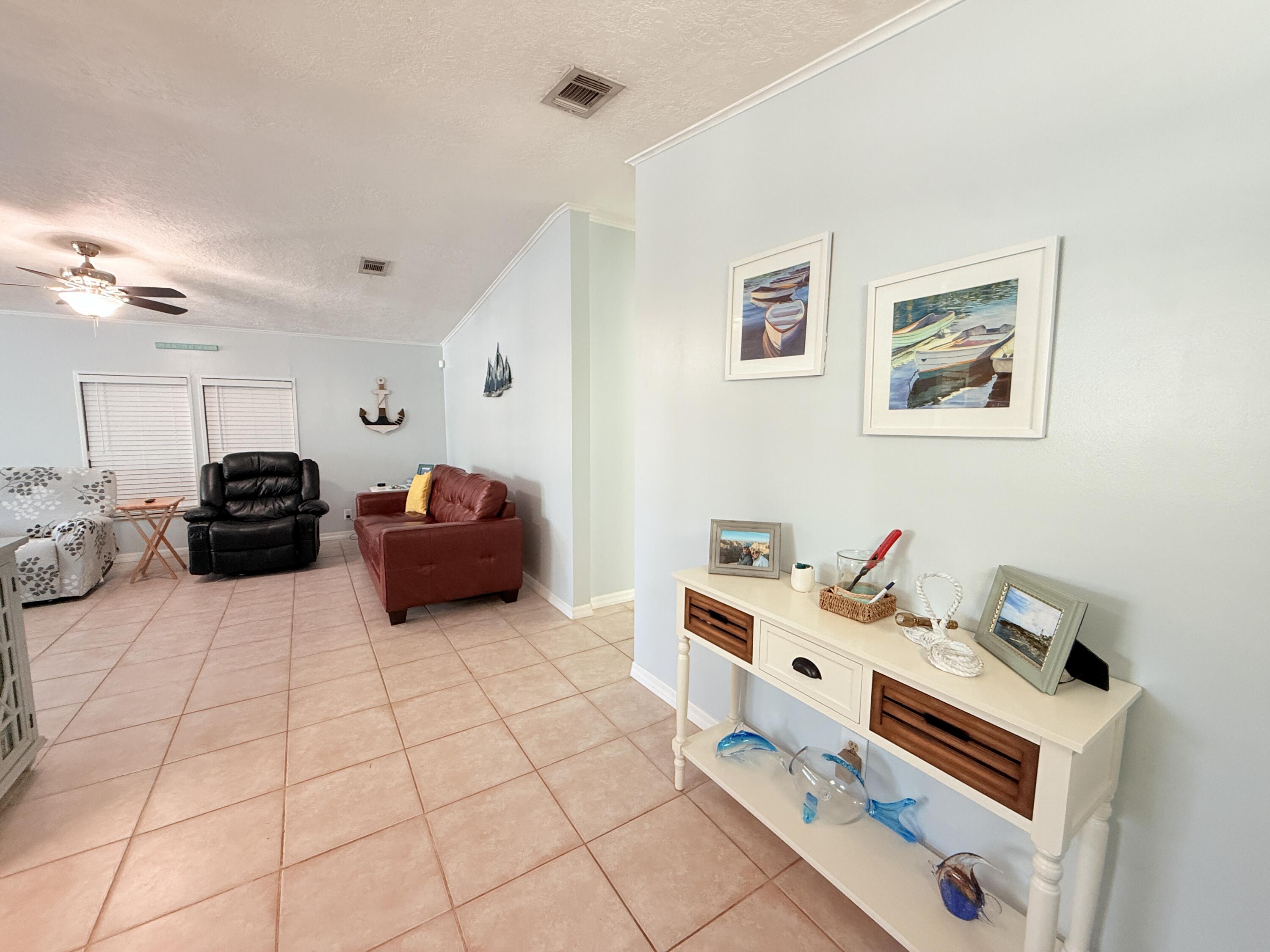 723 Boyd Drive Key Largo, FL 33037 - Photo 12 of 56 a room with furniture and a flat screen tv