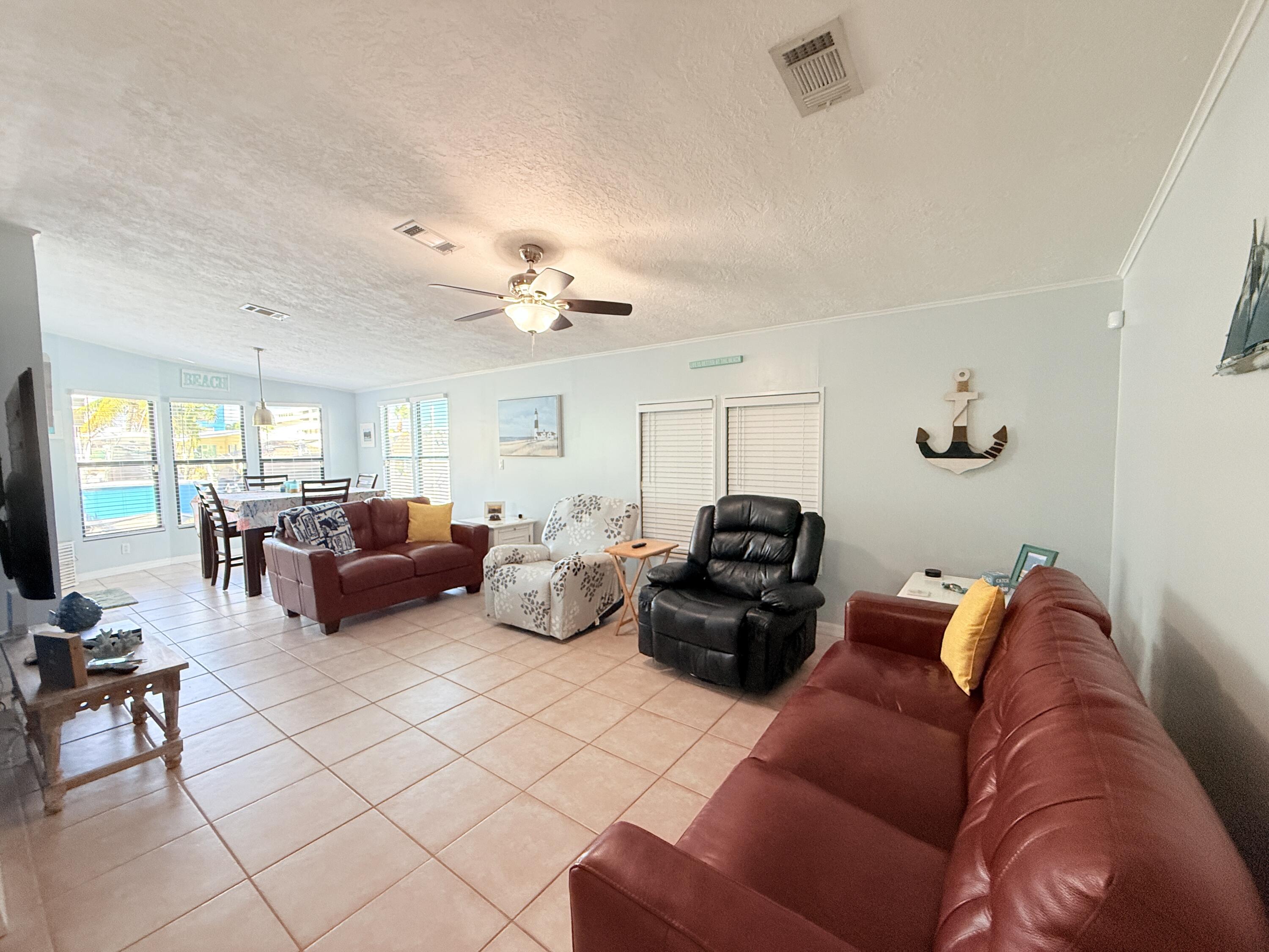723 Boyd Drive Key Largo, FL 33037 - Photo 13 of 56 a living room with furniture ceiling fan and a window