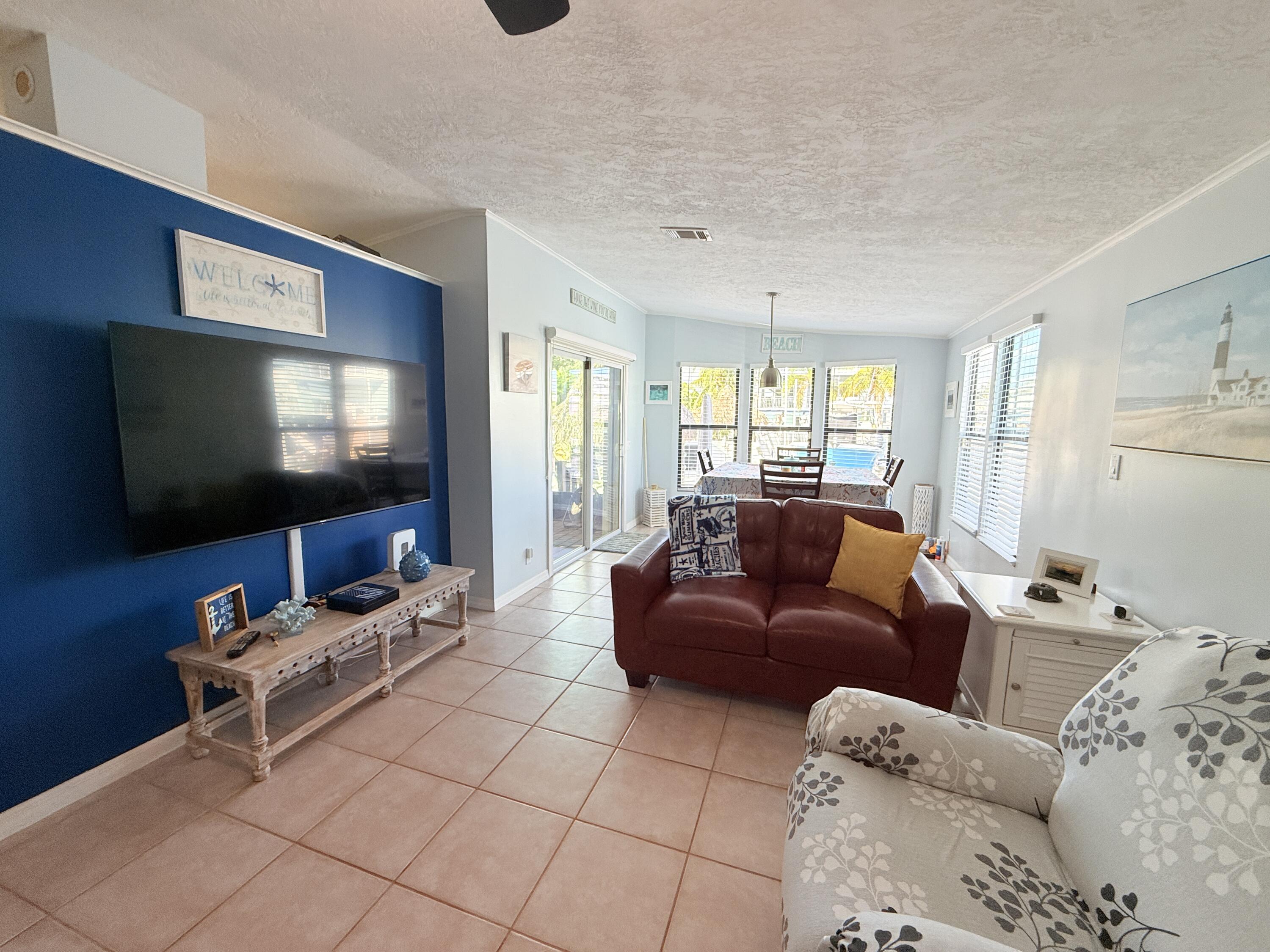 723 Boyd Drive Key Largo, FL 33037 - Photo 17 of 56 a living room with furniture and a flat screen tv