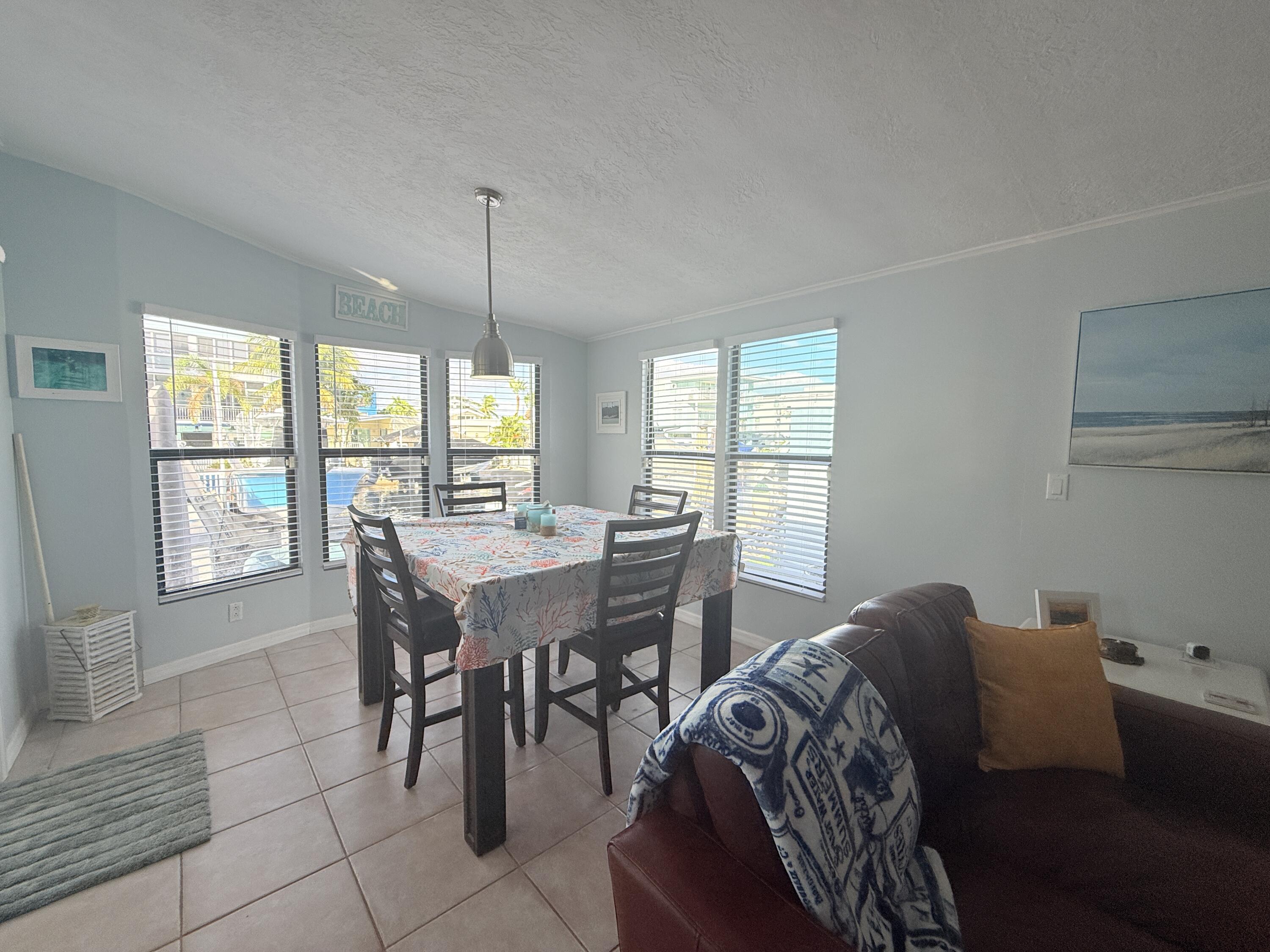 723 Boyd Drive Key Largo, FL 33037 - Photo 19 of 56 a dining room with furniture and window