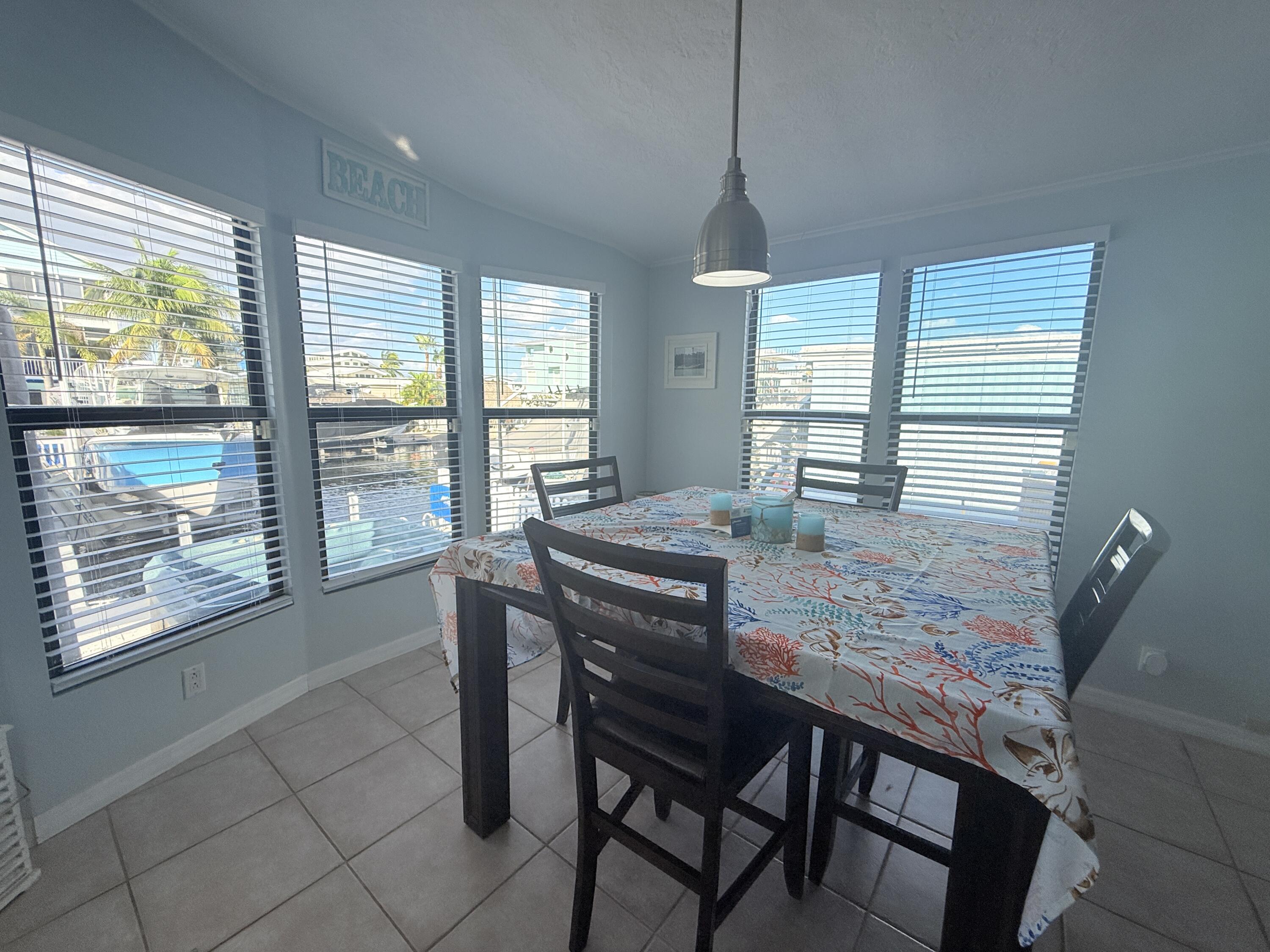 723 Boyd Drive Key Largo, FL 33037 - Photo 21 of 56 a dining room with furniture and window