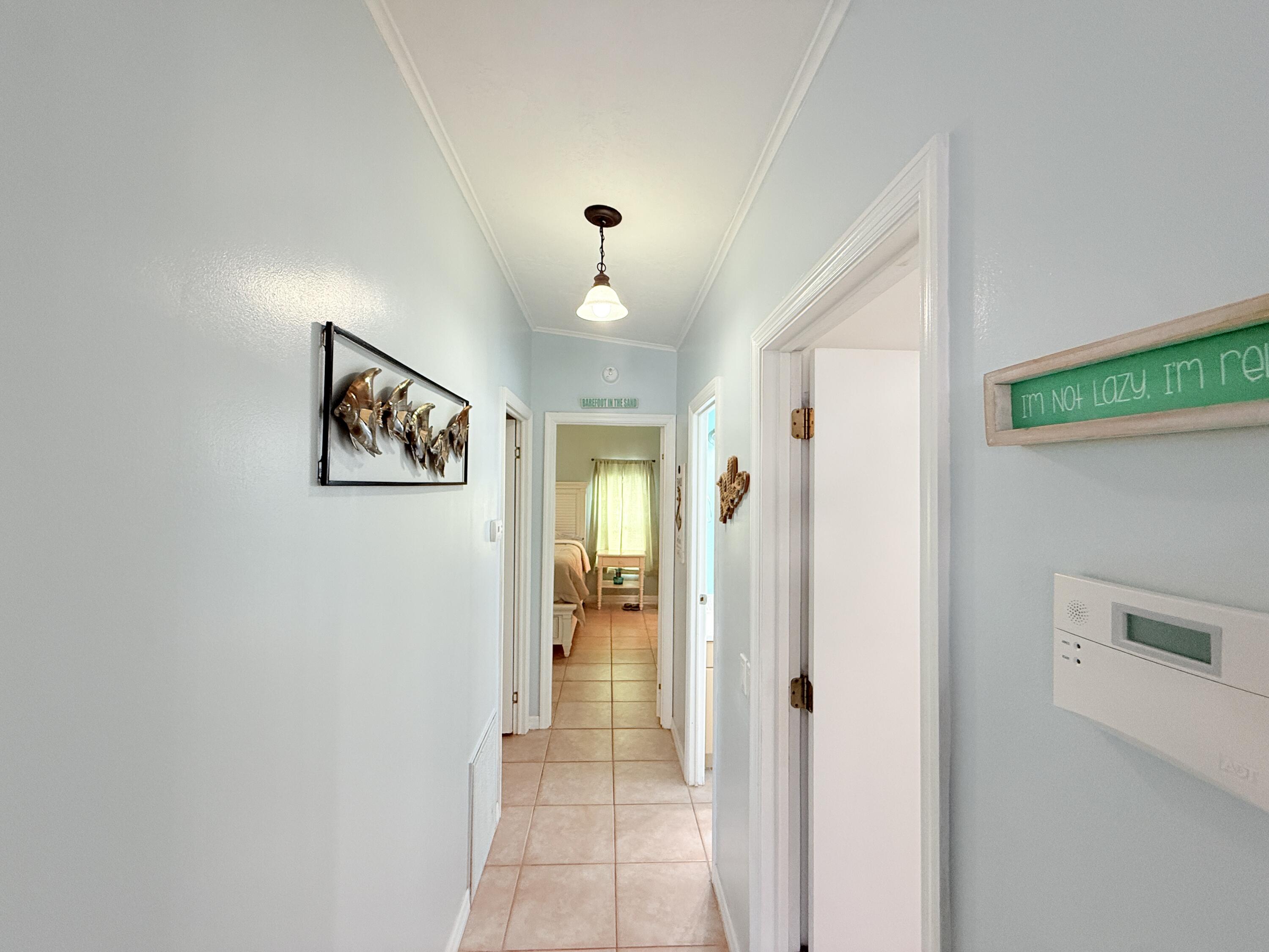 723 Boyd Drive Key Largo, FL 33037 - Photo 22 of 56 a view of a hallway with wooden floor and a living room