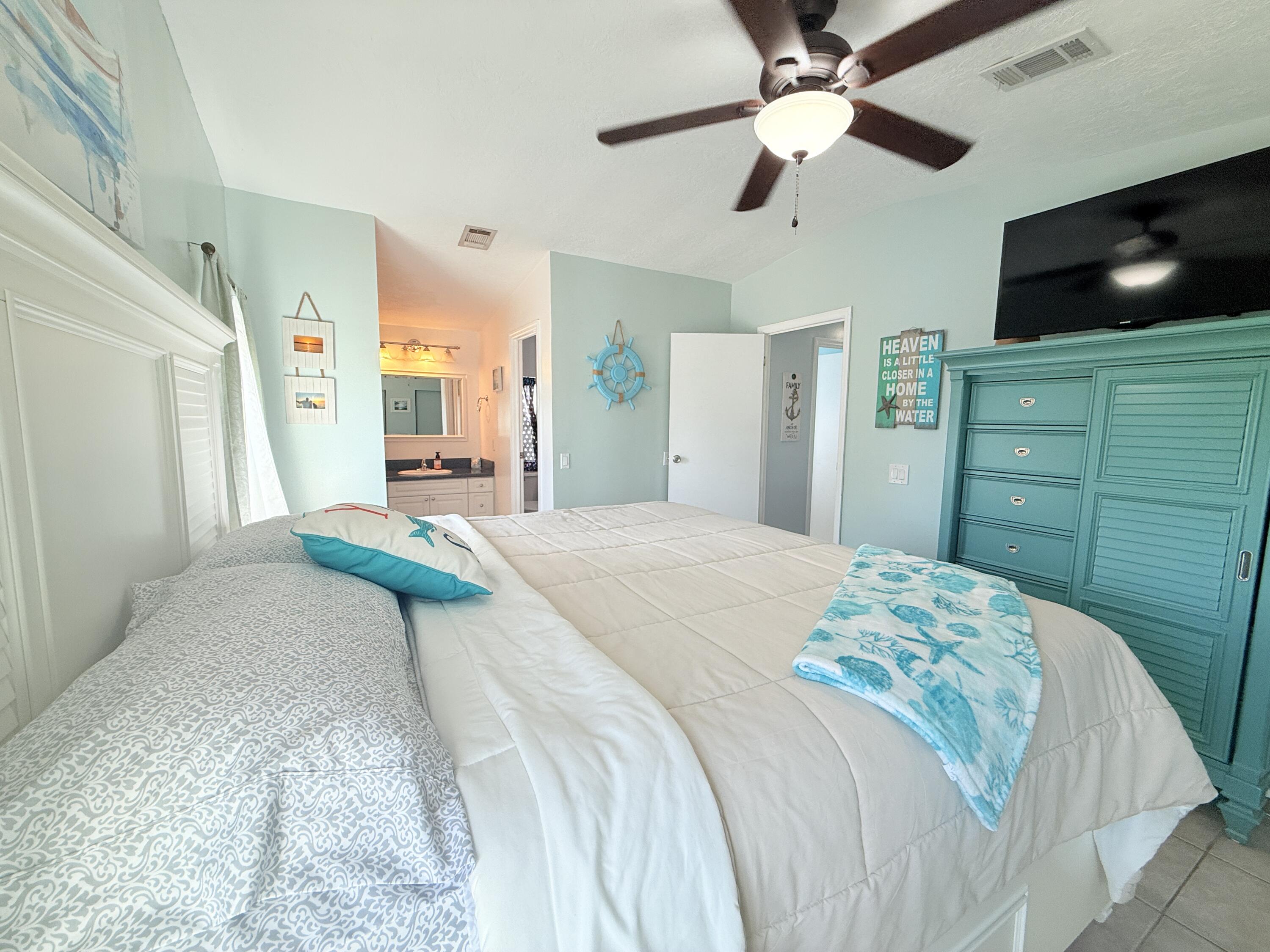 723 Boyd Drive Key Largo, FL 33037 - Photo 26 of 56 a bedroom with a bed and a flat screen tv