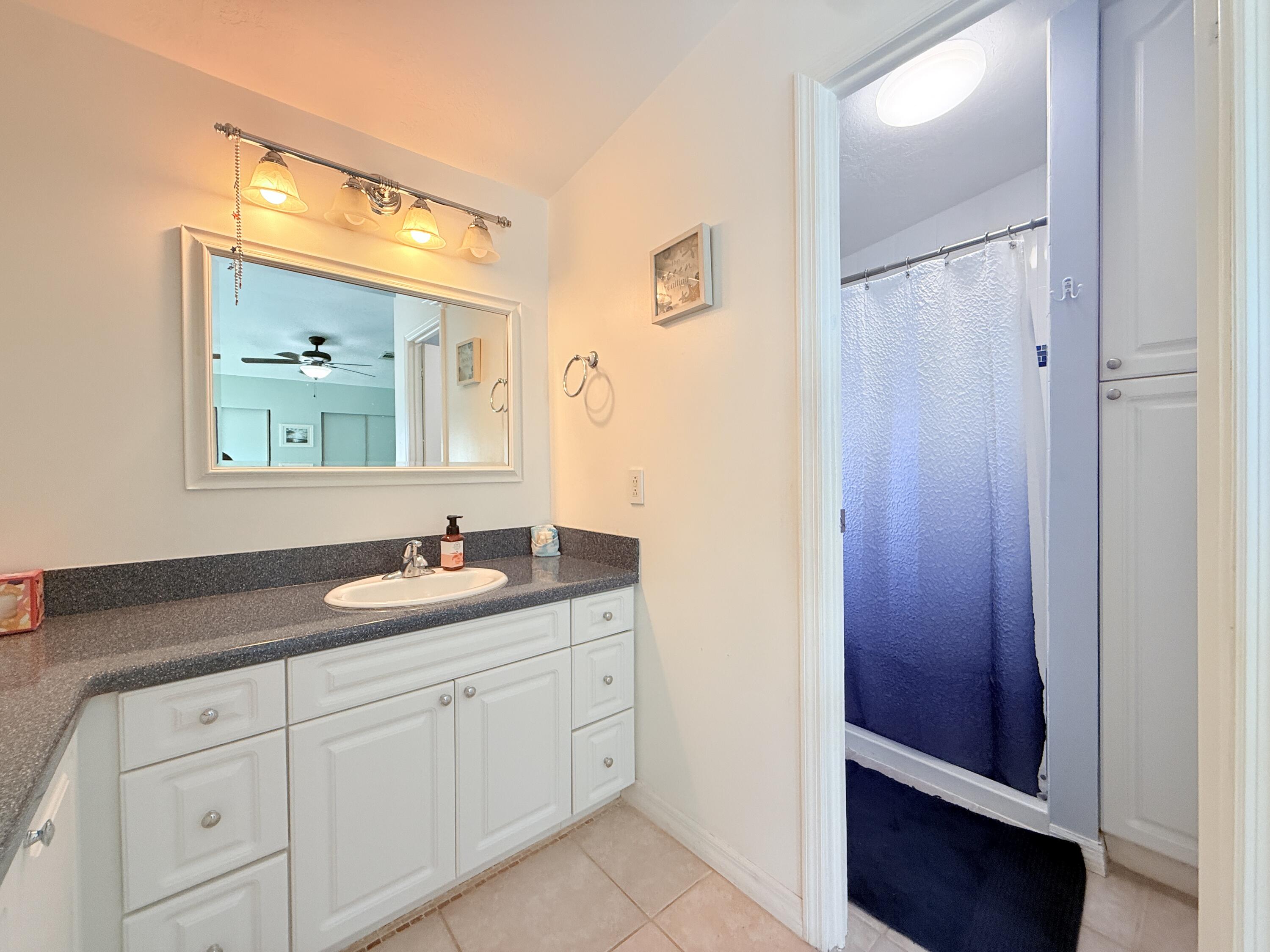 723 Boyd Drive Key Largo, FL 33037 - Photo 27 of 56 a bathroom with a double vanity sink and mirror