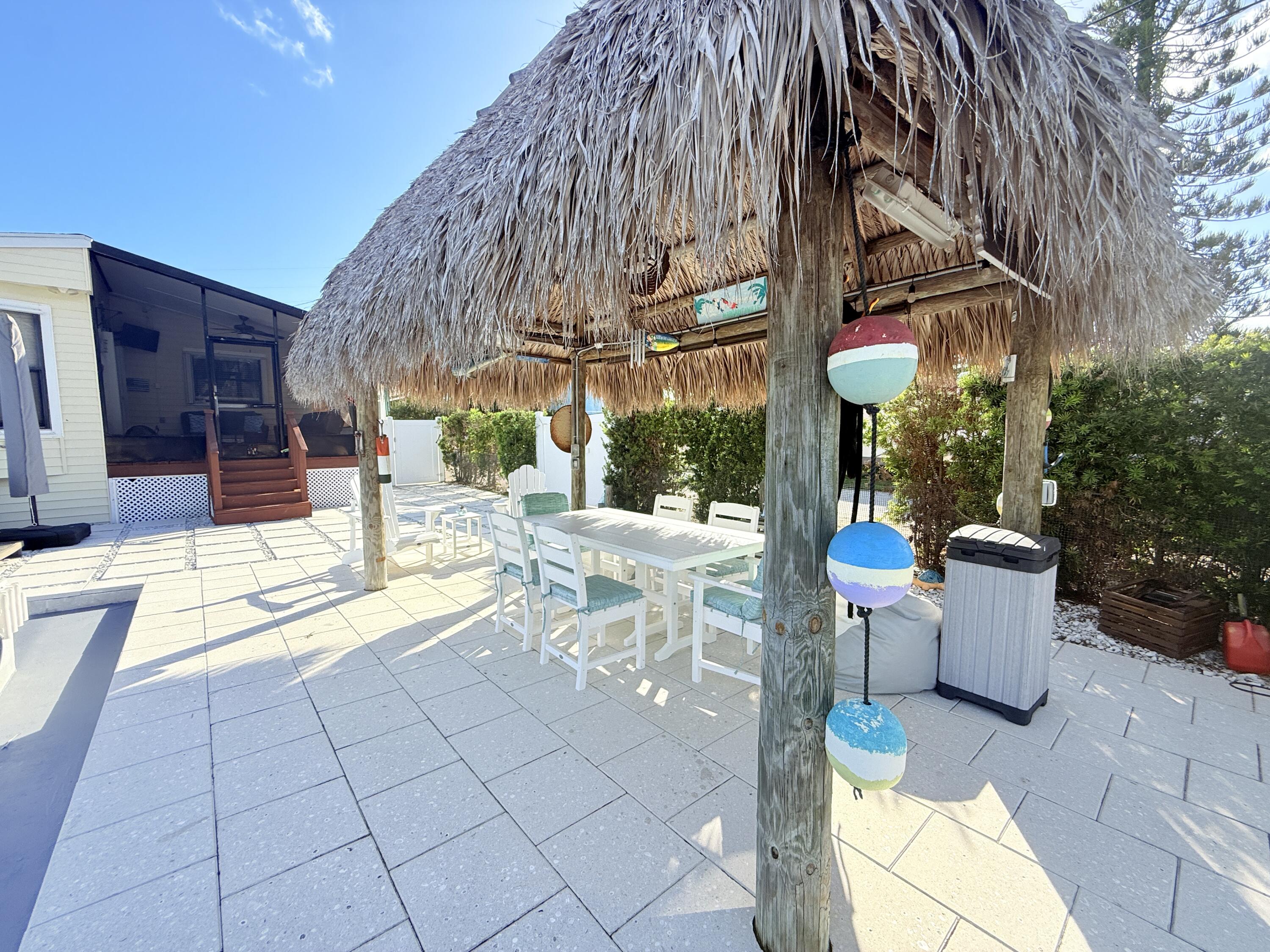 723 Boyd Drive Key Largo, FL 33037 - Photo 3 of 56 a view of a patio with a table and chairs
