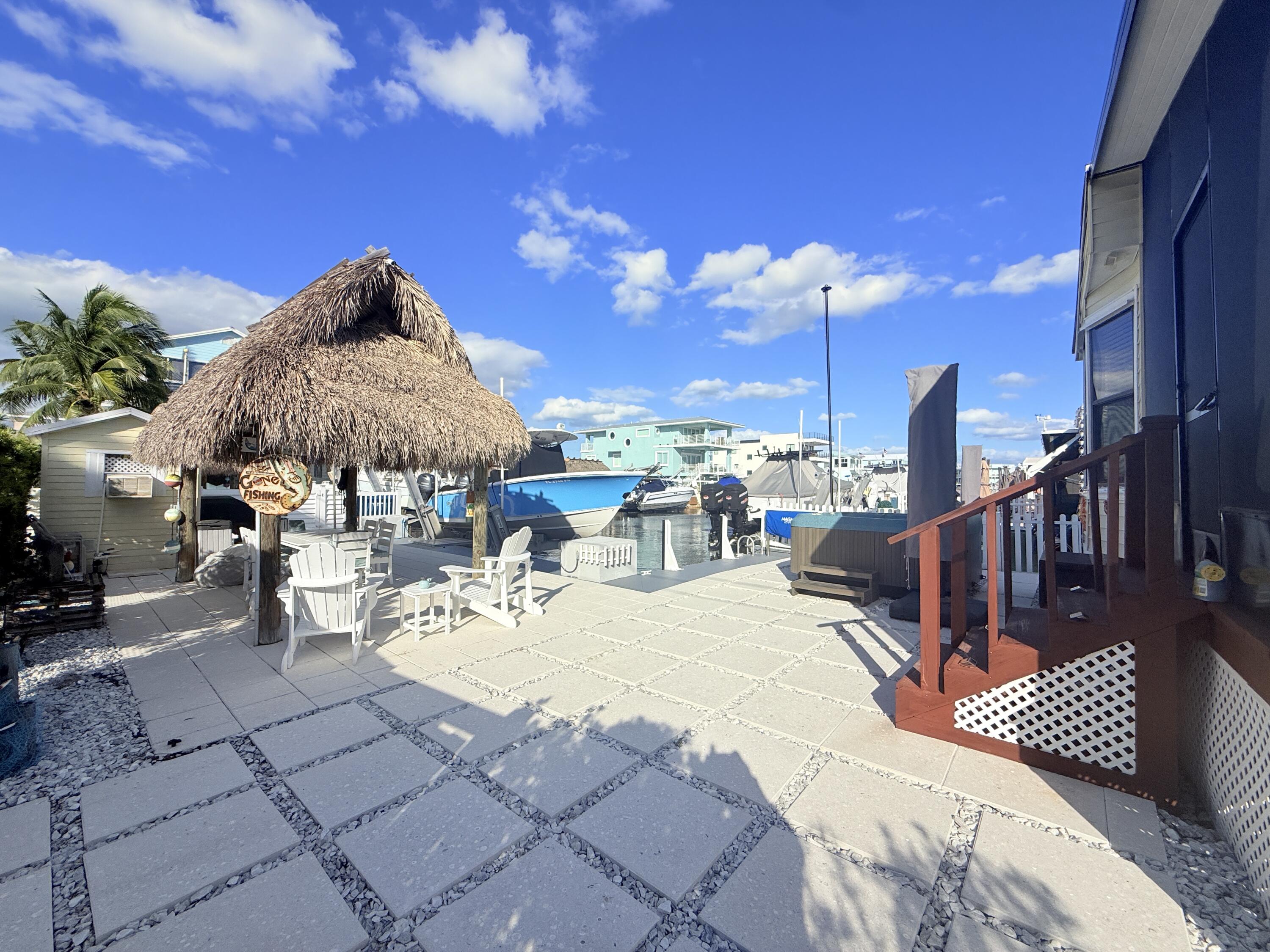 723 Boyd Drive Key Largo, FL 33037 - Photo 40 of 56 a view of a patio with a table chairs and a fire pit