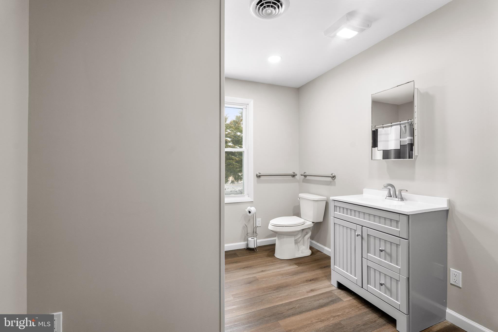 900 New Bridge Road Rising Sun, MD 21911 - Photo 13 of 29 a bathroom with a toilet a sink a mirror and a hardwood