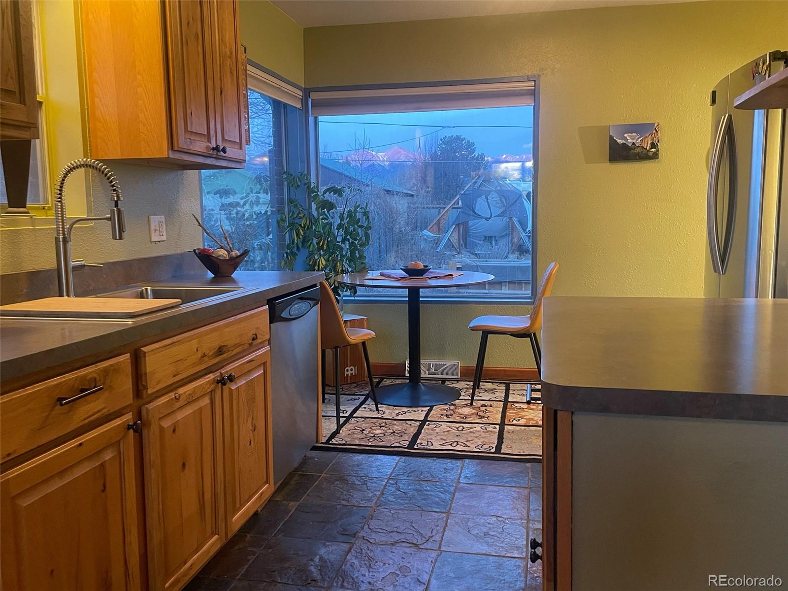 1328 I Street Salida, CO 81201 - Photo 12 of 24 a kitchen with stainless steel appliances granite countertop a refrigerator and a stove