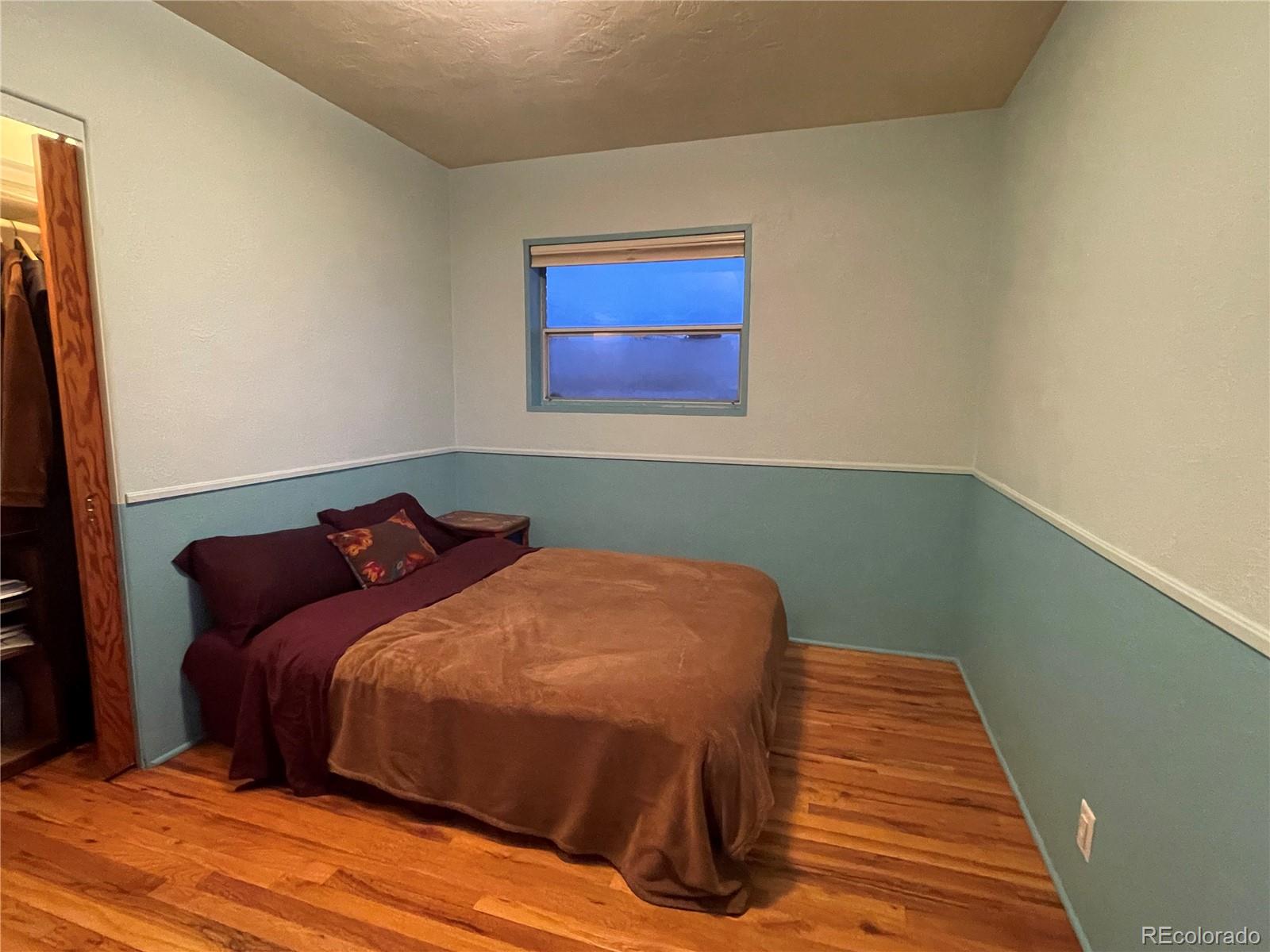 1328 I Street Salida, CO 81201 - Photo 18 of 24 a bedroom with a bed and wooden floor