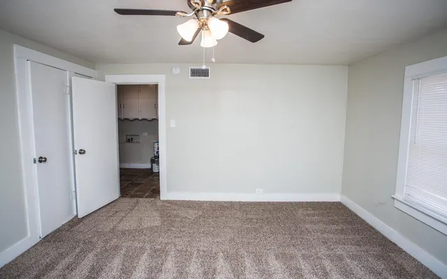a view of walk in closet with empty racks