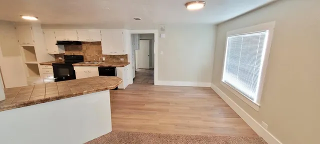 a kitchen with granite countertop wooden cabinets and stainless steel appliances