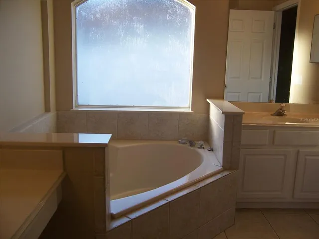 a bathroom with a bathtub and sink