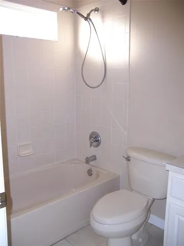 a bathroom with a toilet and a bath tub