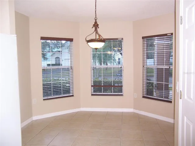 a view of an empty room with a window and balcony