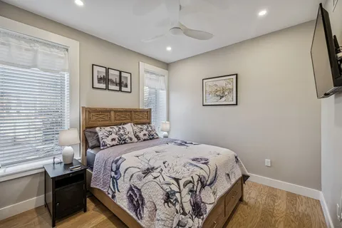 a bedroom with a large bed and a chandelier
