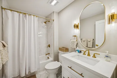 a bathroom with a sink toilet and shower