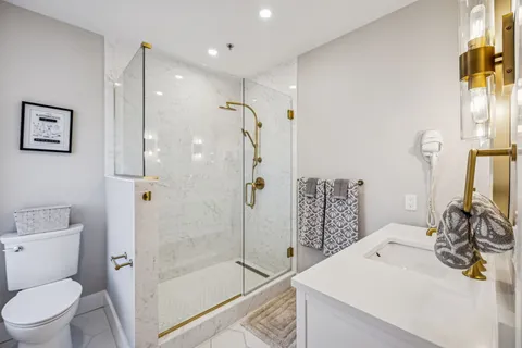 a bathroom with a sink toilet and shower