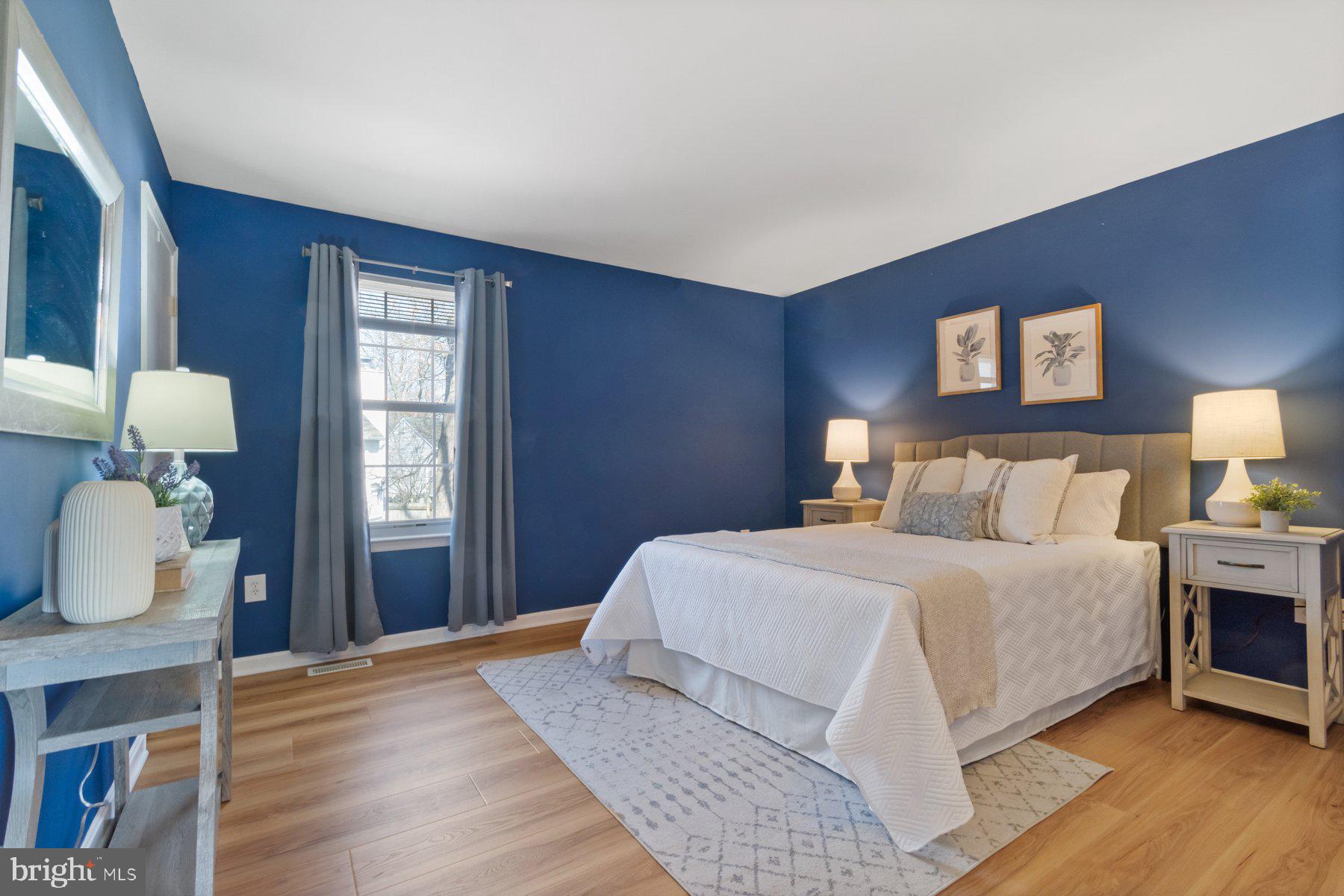 1512 Pullman Drive Severn, MD 21144 - Photo 12 of 34 a bedroom with a bed and wooden floor