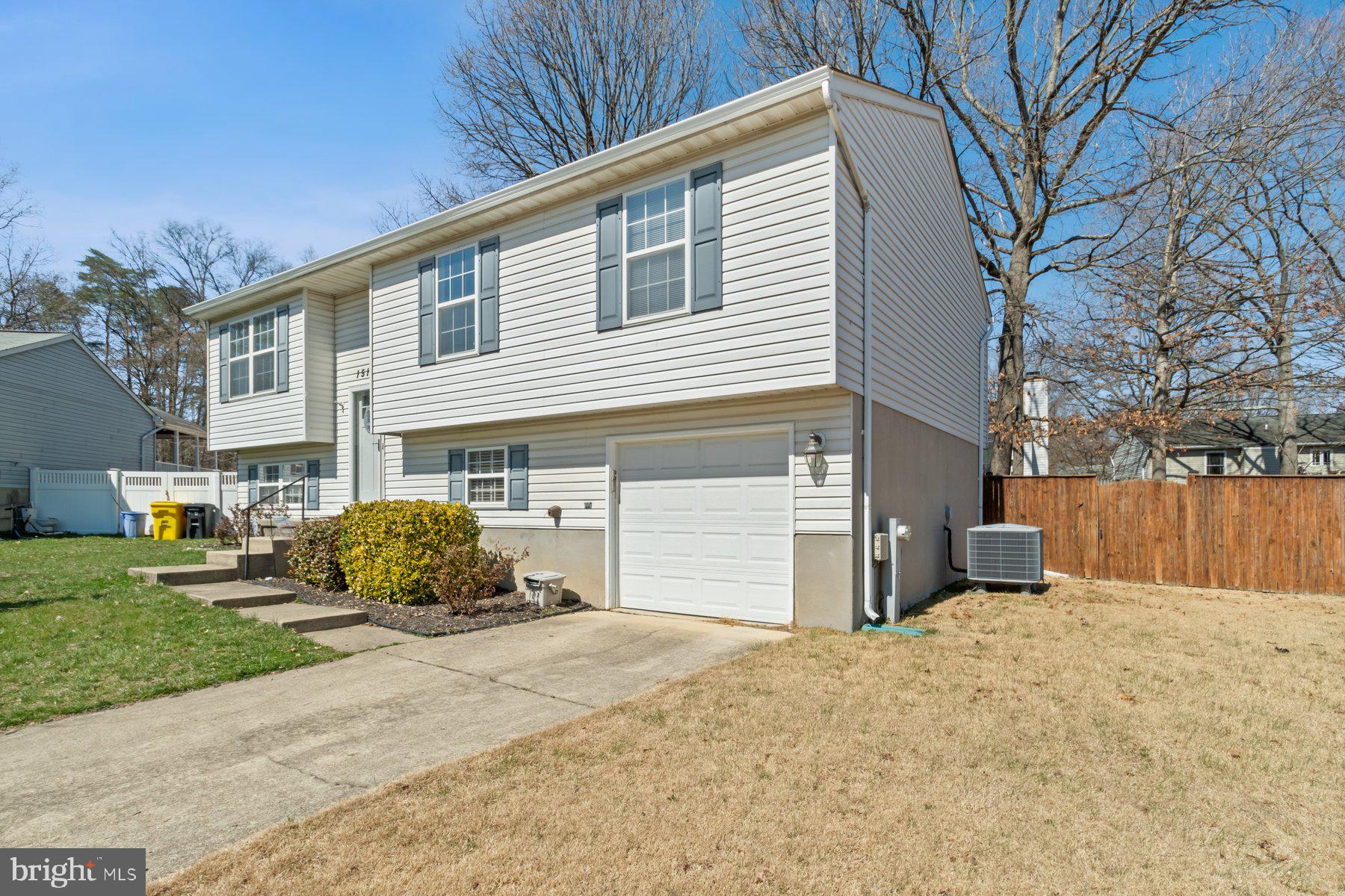 1512 Pullman Drive Severn, MD 21144 - Photo 30 of 34 a front view of a house with a yard and garage